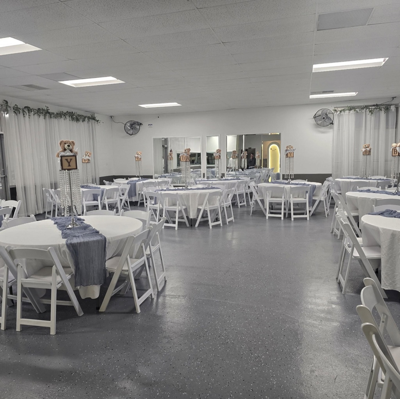 A baby shower in dusty blue with teddy bear and crystal centerpieces