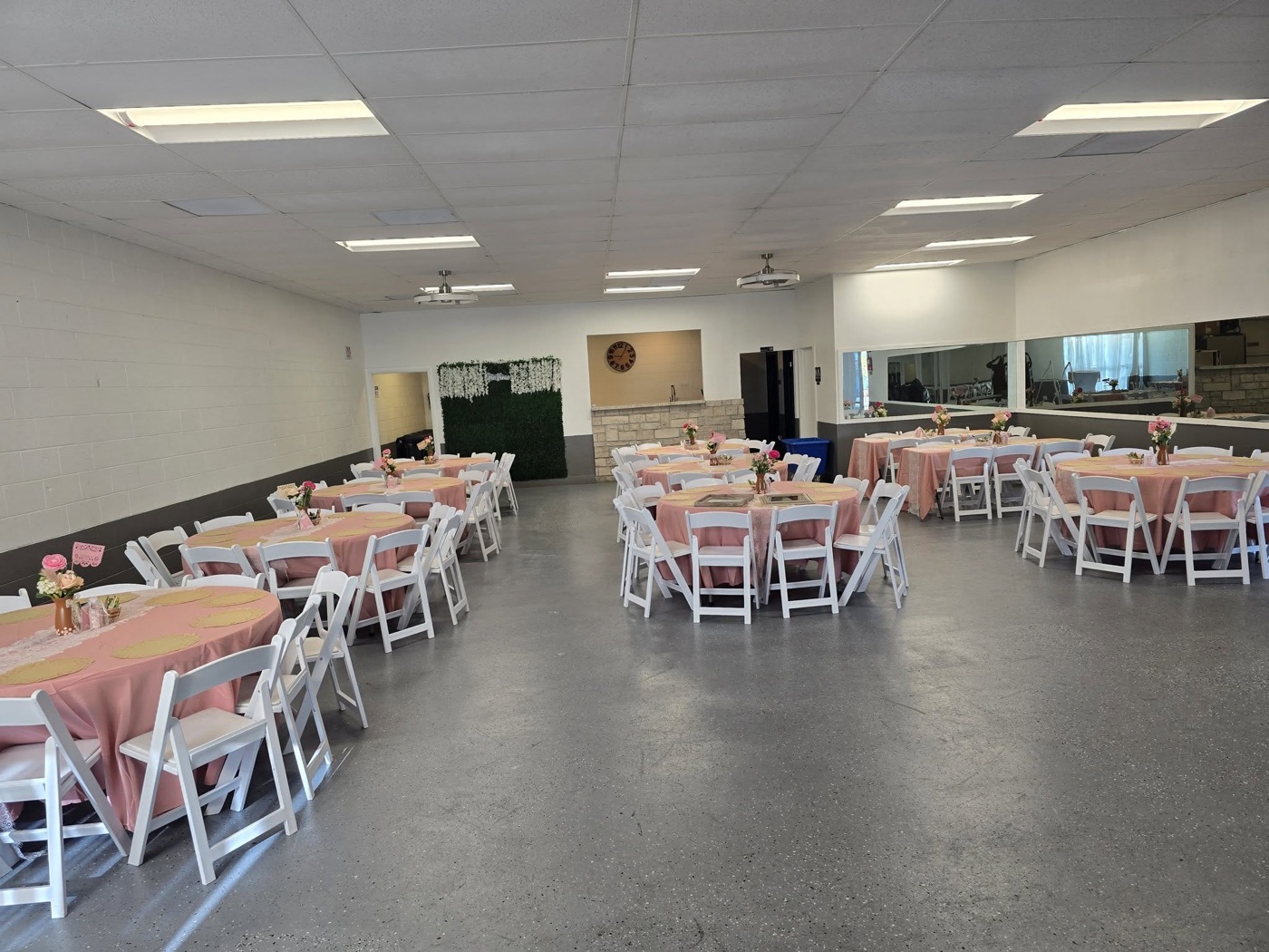 The hall set in blush and gold with the greenery photo wall
